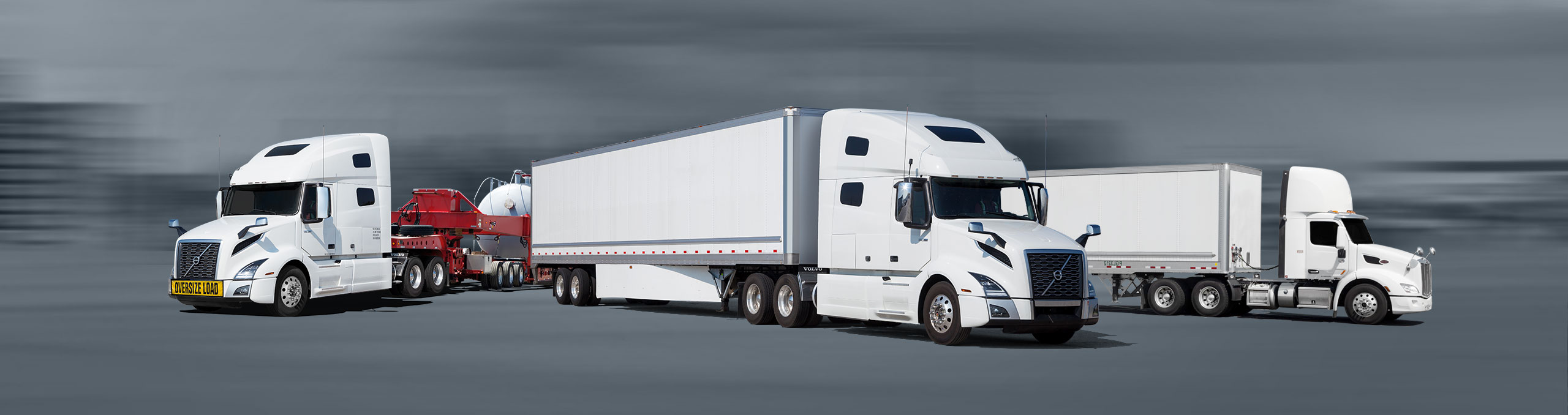 Transport trucks with a flatbed and two dry van trailers